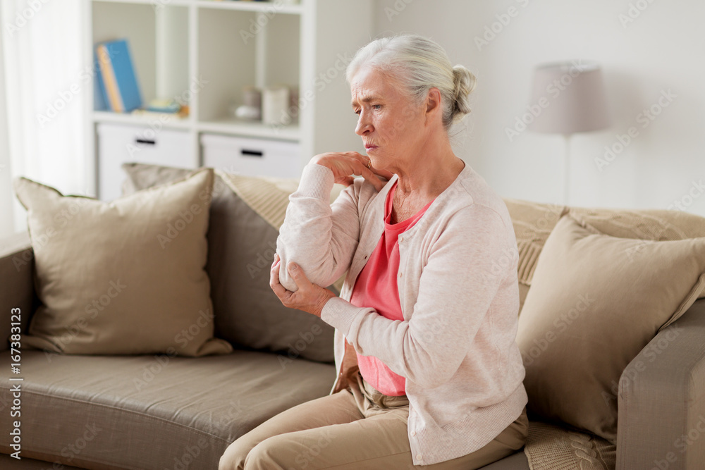 senior woman suffering from pain in hand at home senior woman suffering from pain in hand at home