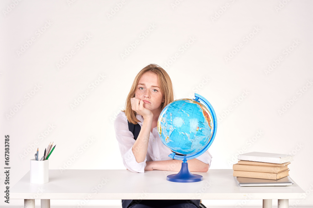 Portrait of red-haired female student studying at desk Portrait of red-haired female student studying at desk