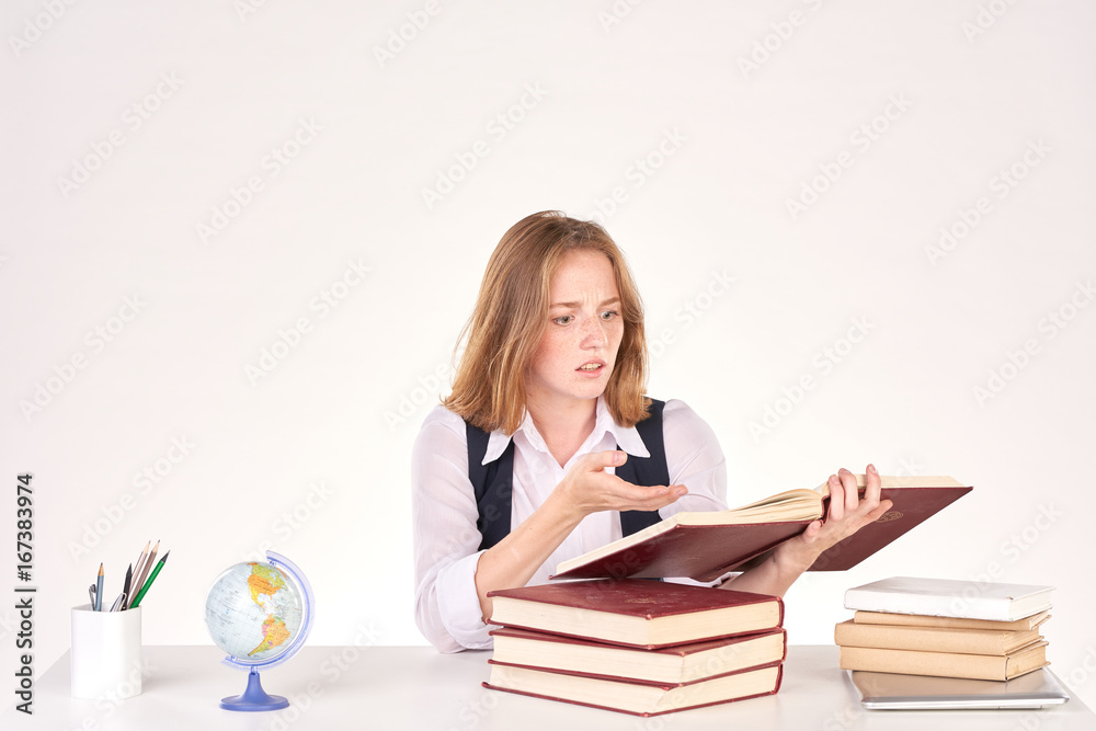 Portrait of red-haired female student studying at desk Portrait of red-haired female student studying at desk