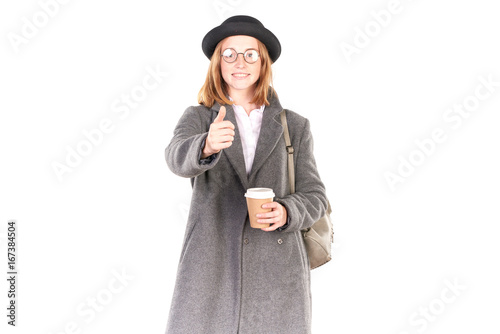 Portrait of teenage hispter girl wearing gray overcoat and black hat isolated on white photo