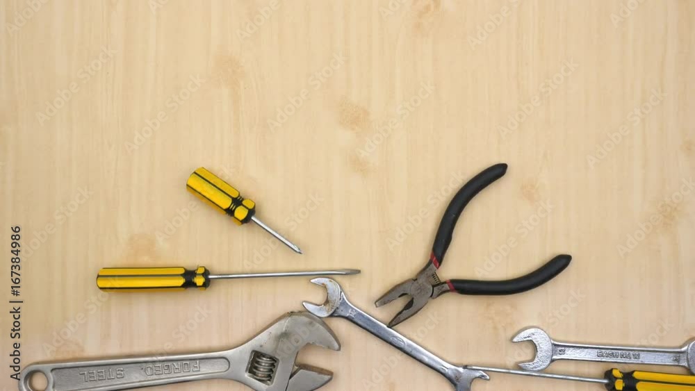 Moving construction tools on wooden table, stop motion animation Moving construction tools on wooden table, stop motion animation