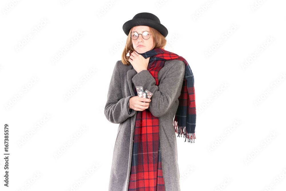 Portrait of teenage girl wearing gray coat, hat and scarf feeling flu symptoms Portrait of teenage girl wearing gray coat, hat and scarf feeling flu symptoms