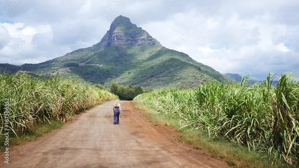 Woman walks to mountain, slow motion Woman walks to mountain, slow motion