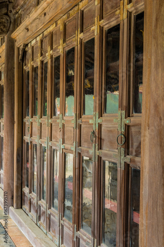The corridor with the wood windows at Tu Duc tomb in Hue Vietnam © Hai791313