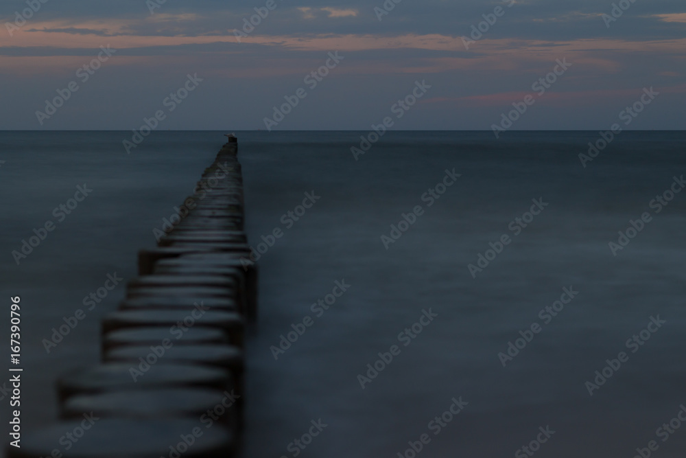 Obraz premium breakwater at sunset 