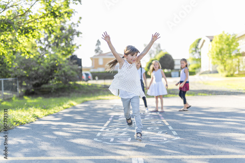 cheerful school age child play on playground school