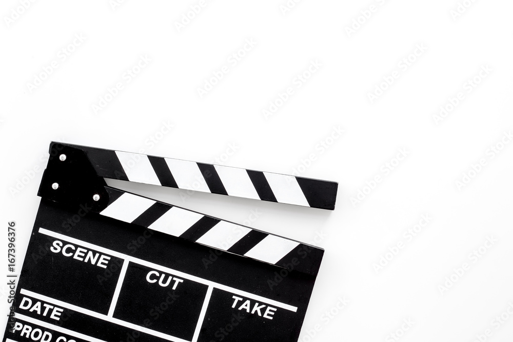 Fototapeta premium Filmmaker profession. Clapperboard on white background top view copyspace