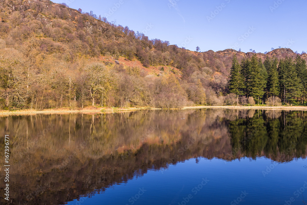 Fototapeta premium Yew Tree Tarn, small lake in the English Lake District situated in between the towns of Ambleside and Coniston, Cumbria, England.
