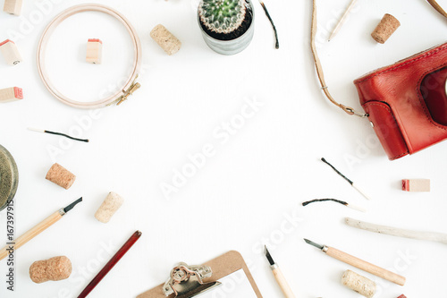 Layout with copy space made of retro camera, succulent, tools for handmade arts, clipboard on white background. Top view, flat lay hipster artist concept.