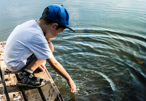 a boy plays in the water on the river