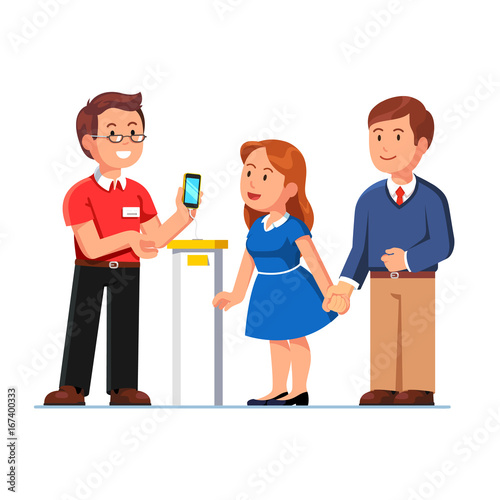 Shop assistant showing smartphone to customers