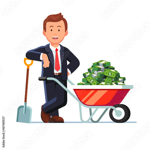 Businessman standing next to wheelbarrow with cash