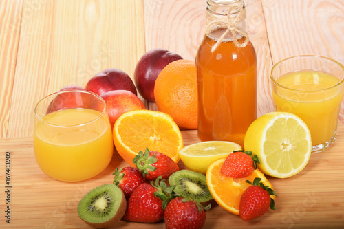 Orange juice freshly squeezed in the company of various fruits