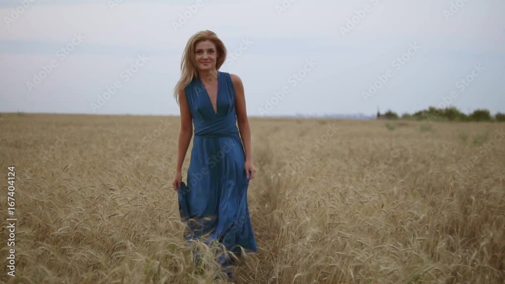 Beautiful young happy girl running through wheat field. Freedom concept. Turning around and looking to the camera. Slowmotion shot Beautiful young happy girl running through wheat field. Freedom concept. Turning around and looking to the camera. Slowmotion shot