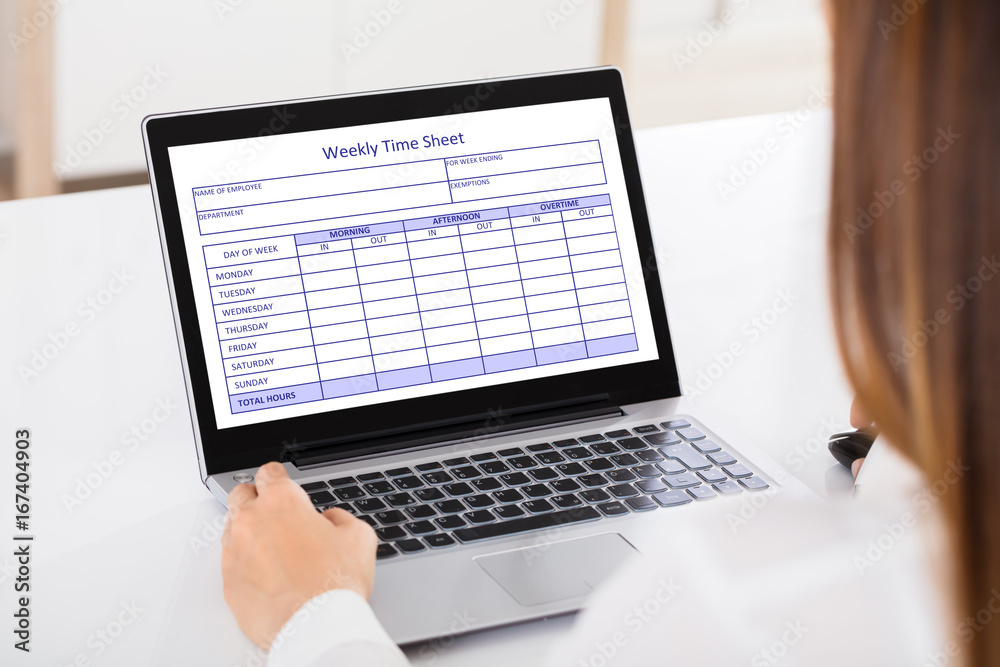 Businesswoman Filling Weekly Time Sheet Businesswoman Filling Weekly Time Sheet
