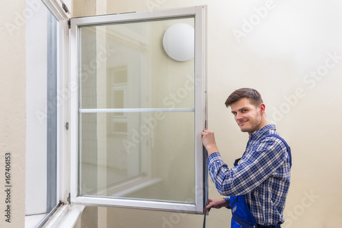 Repairman Fixing Window