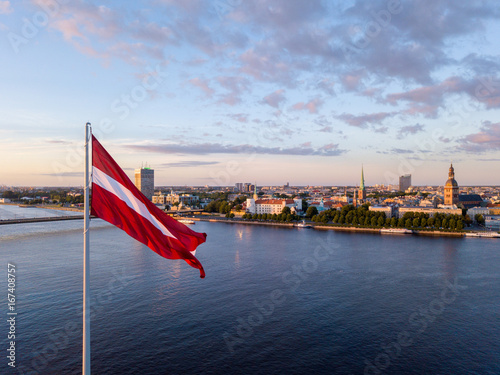 Schilderij op canvas Beautiful aerial sunset view over AB dam in Riga Latvia with a huge Latvian flag