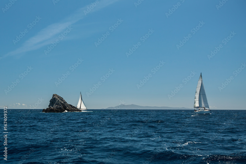 Sailing in the wind through the waves at Sea. Luxury yachts at Regatta.