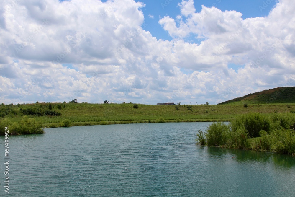 A view of the lake and the park landscape from the shore of the lake. A view of the lake and the park landscape from the shore of the lake.