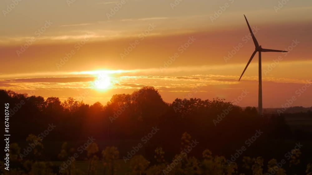 Wind turbines farms with rays of light at sunset in the background. Wind turbines farms with rays of light at sunset in the background.