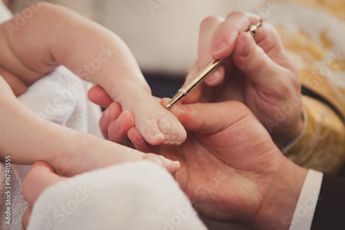 Baby feet in mommy's hand. Christening. Baptism. Orthodox
