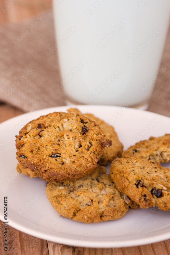 Chocolate chip cookies with milk in glass on wood table. Chocolate chip cookies with milk in glass on wood table.
