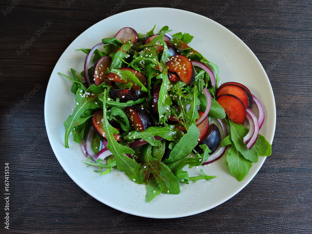 Fitness salad with plums and blue onions. Top view. Fitness salad with plums and blue onions. Top view.