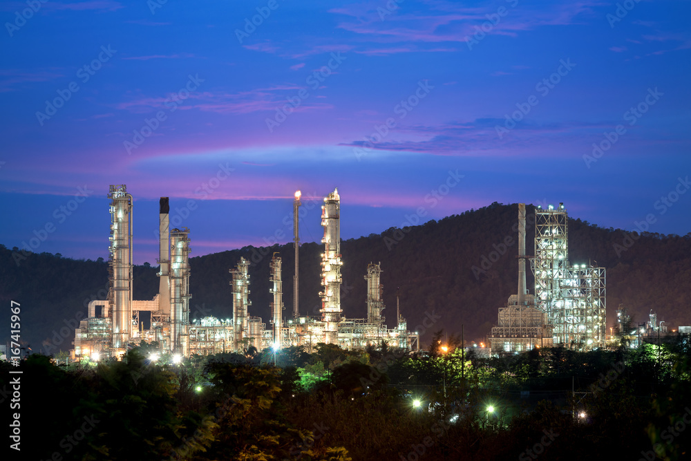 Naklejka premium Landscape of oil refinery industry with oil storage tank in night.