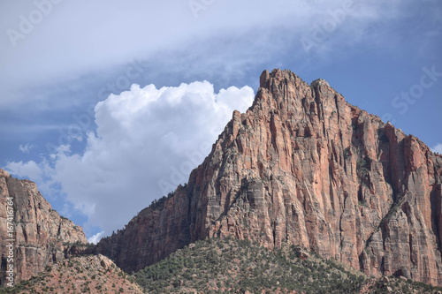 View of a mountain with sharp peak, blue sky, and a big puffy white cloud,  Zion National Park, Utah © Kathleen