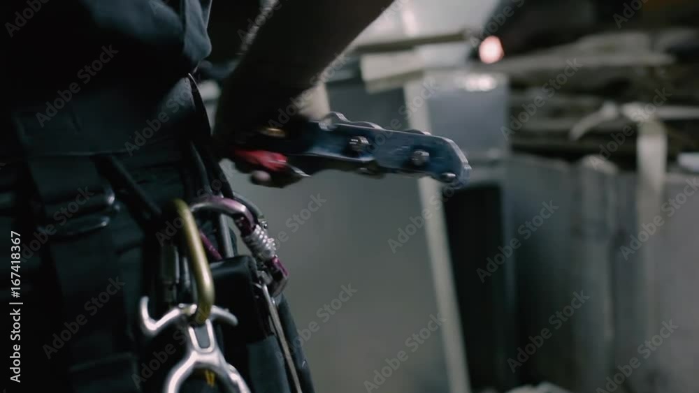 The steeplejack checks the equipment on the clothes The steeplejack checks the equipment on the clothes