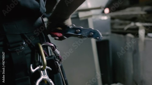The steeplejack checks the equipment on the clothes