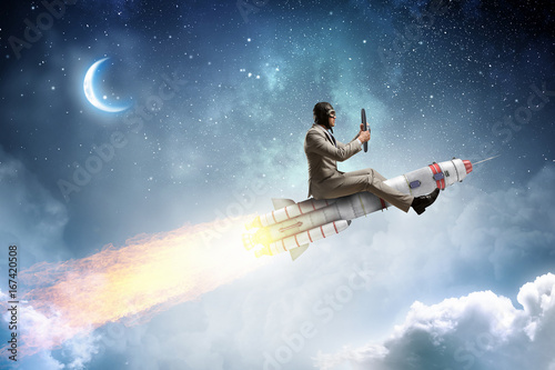 Foto Aviator riding rocket. Mixed media