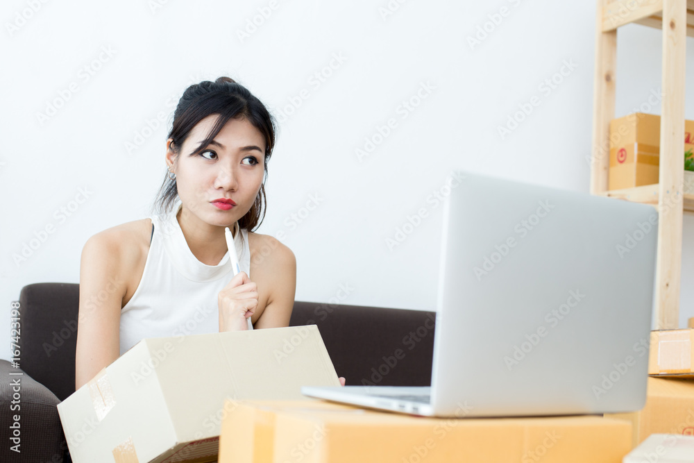 Young Asian Woman Working at home, Young Owner Woman Strat up for Business Online, SME, Delivery Project, Woman with Online Business or SME Concept. Young Asian Woman Working at home, Young Owner Woman Strat up for Business Online, SME, Delivery Project, Woman with Online Business or SME Concept.