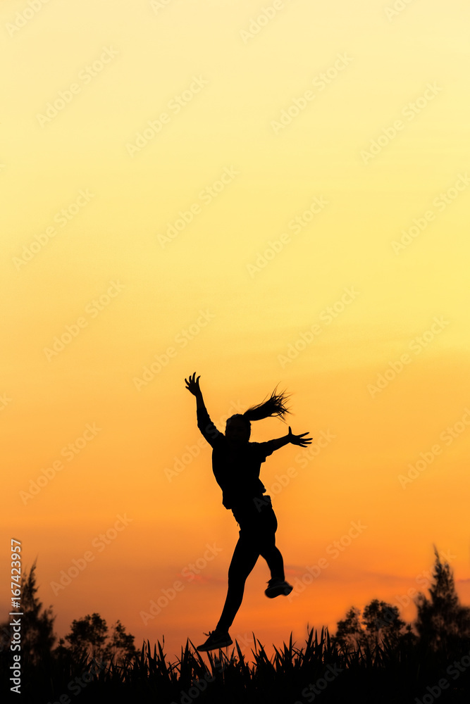 Silhouette of free woman enjoying freedom feeling happy at sunset. relaxing woman in pure happiness Silhouette of free woman enjoying freedom feeling happy at sunset. relaxing woman in pure happiness