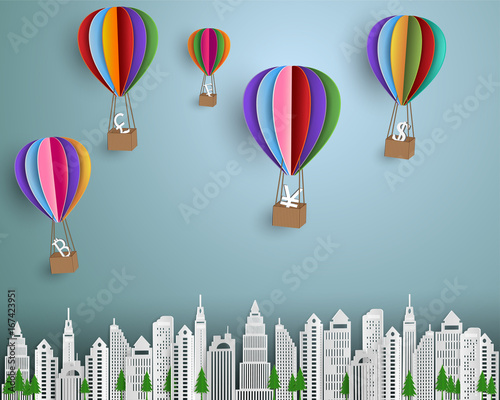 Business and finance concept,group of currency sign with colorful hot air balloon floating on the city,paper art style