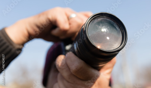 A large lens in the camera of a man