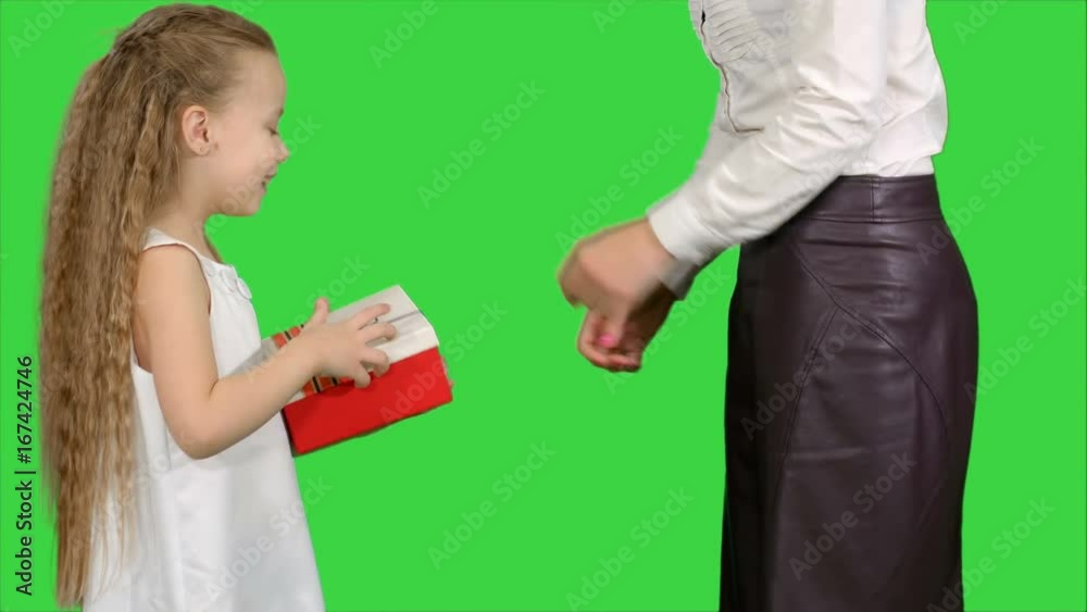 Young charming mother and her cute daughter opened Christmas gifts on a Green Screen, Chroma Key Young charming mother and her cute daughter opened Christmas gifts on a Green Screen, Chroma Key
