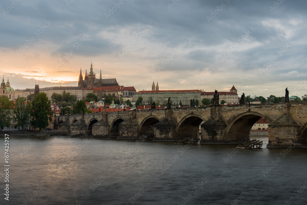 Prague Castle with cloudy sunset and Charles Bridge.