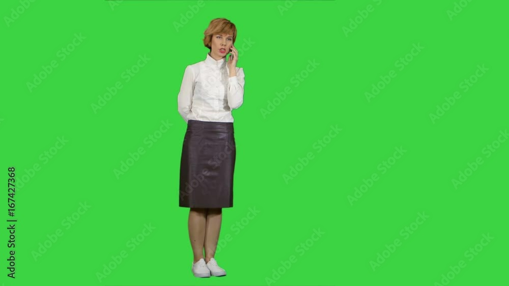 Smiling woman having a phone call on a Green Screen, Chroma Key Smiling woman having a phone call on a Green Screen, Chroma Key