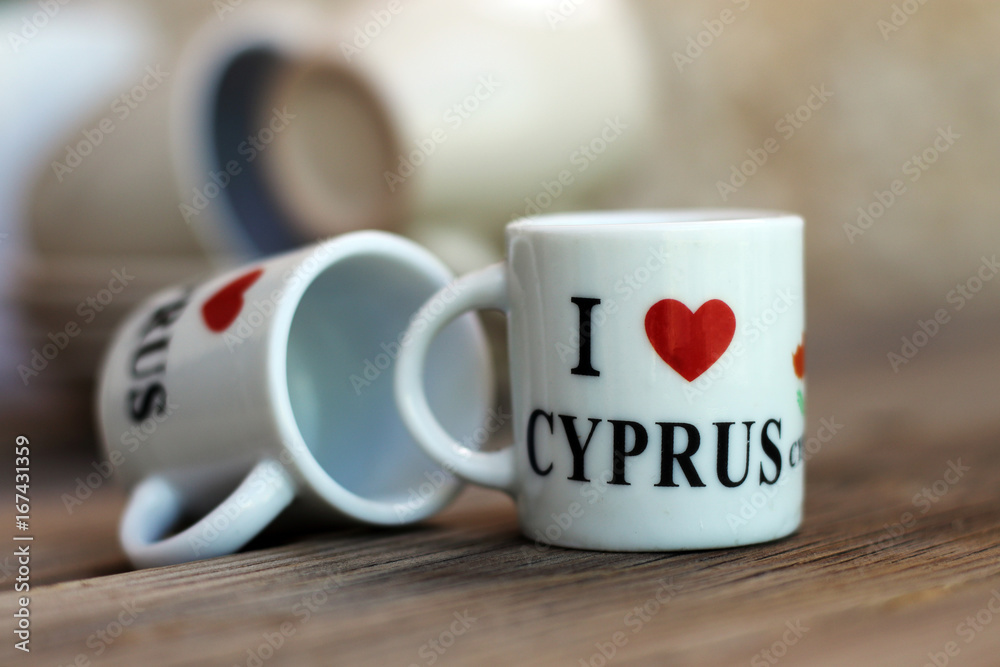 A couple of tiny souvenir cups for coffee, with an inscription