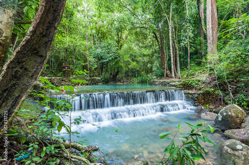 Jungle stream flowing into a small pool, with surrounding rain forest at Paeng Waterfall, Ko Pha Ngan, Thailand. photo