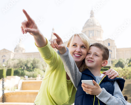 Mother and son pointing at sight photo