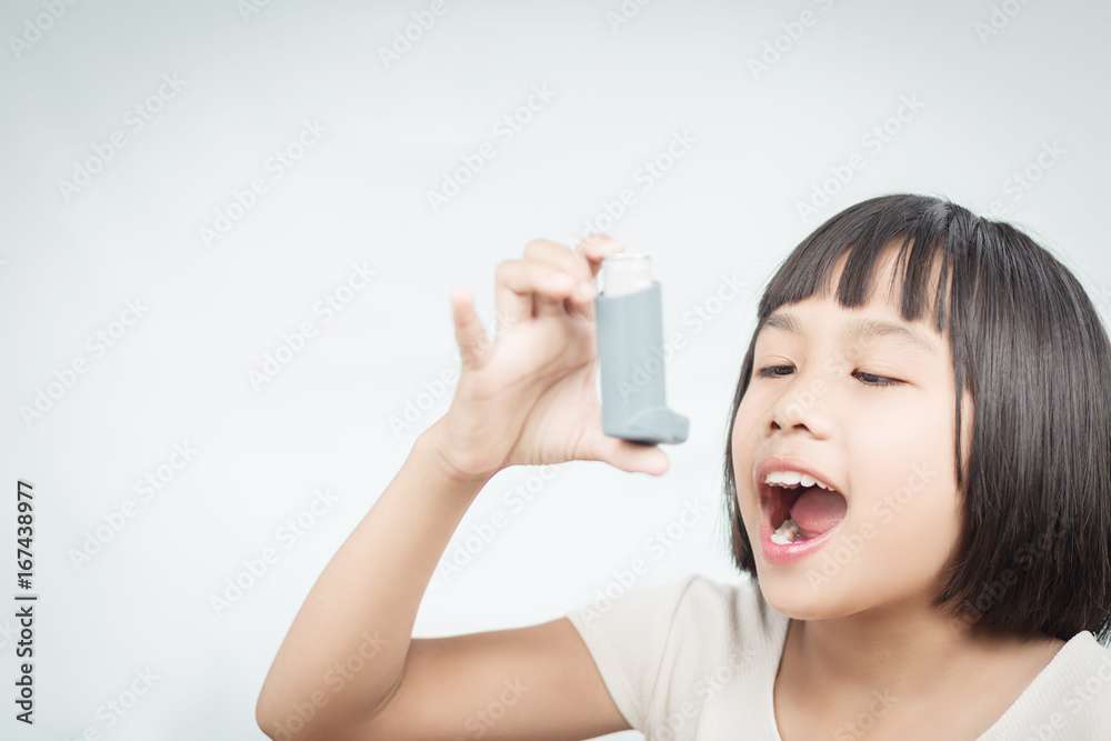Little girl using Asthma inhaler for breathing. Little girl using Asthma inhaler for breathing.