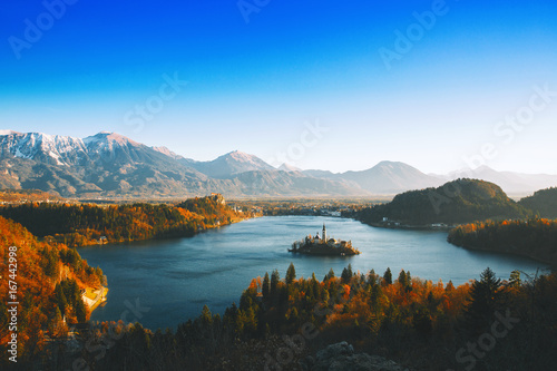 Bled Lake with Island with Catholic Church, Castle and Alps. photo