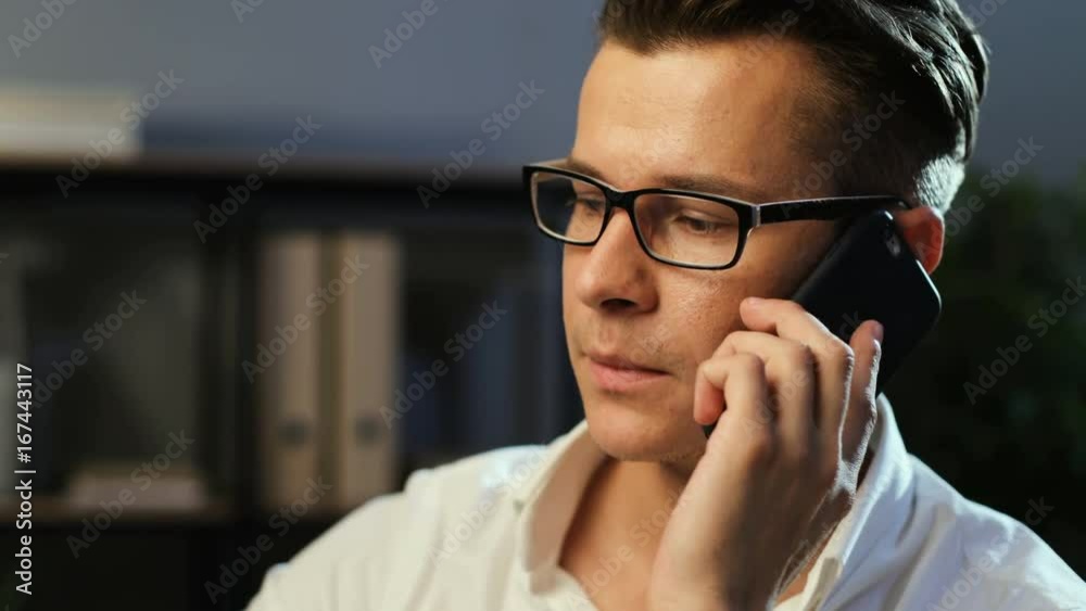 Young business man using smart phone for talking with partner in the office background during the work day. Young business man using smart phone for talking with partner in the office background during the work day.