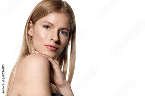 Portrait of a blonde woman with long shiny hair on a white background