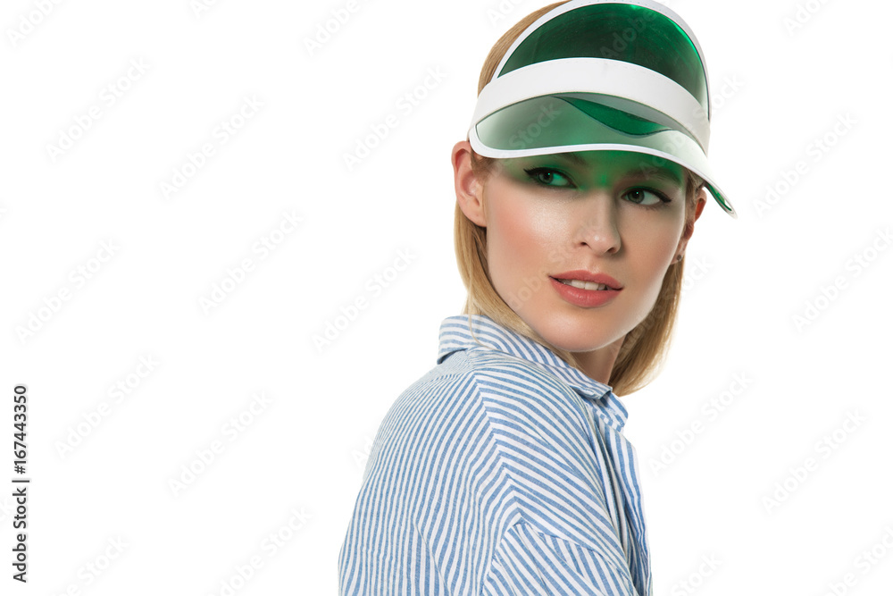Beautiful blonde girl with good skin of the face in a sunny color visor of a green color on a white background Beautiful blonde girl with good skin of the face in a sunny color visor of a green color on a white background