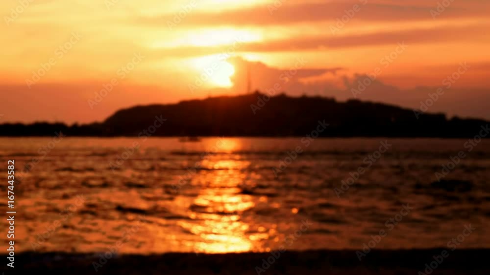 Close up of wine glasses clinking in front of colorful orange ocean sunset during romantic dinner. Shot with Sony a7s and Atomos Ninja Flame in Gili Meno, Indonesia. Close up of wine glasses clinking in front of colorful orange ocean sunset during romantic dinner. Shot with Sony a7s and Atomos Ninja Flame in Gili Meno, Indonesia.