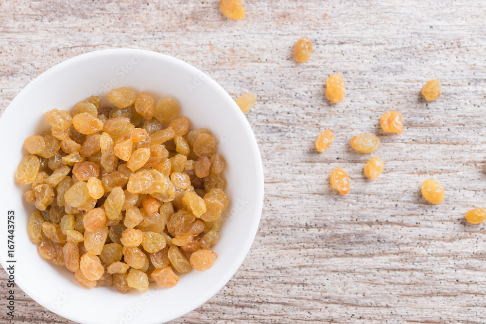 Dried yellow raisin fruits on wood background Dried yellow raisin fruits on wood background