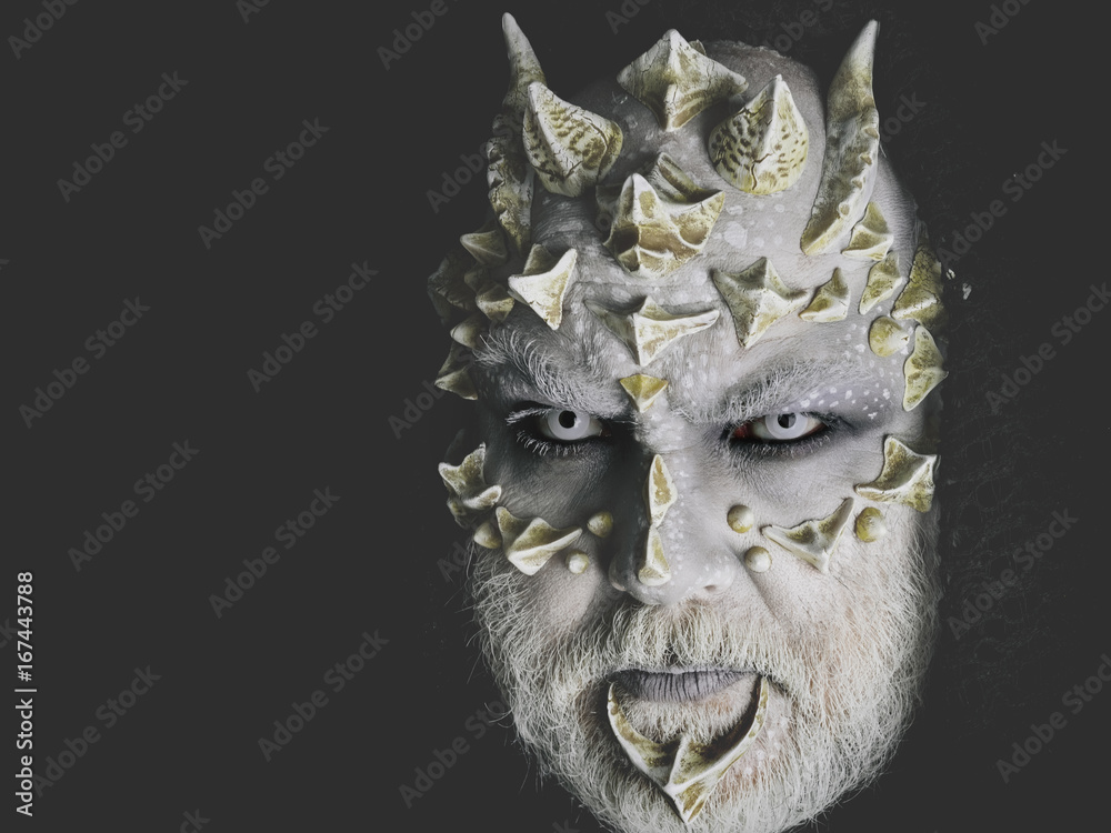 man or monster with thorns on face with futuristic makeup